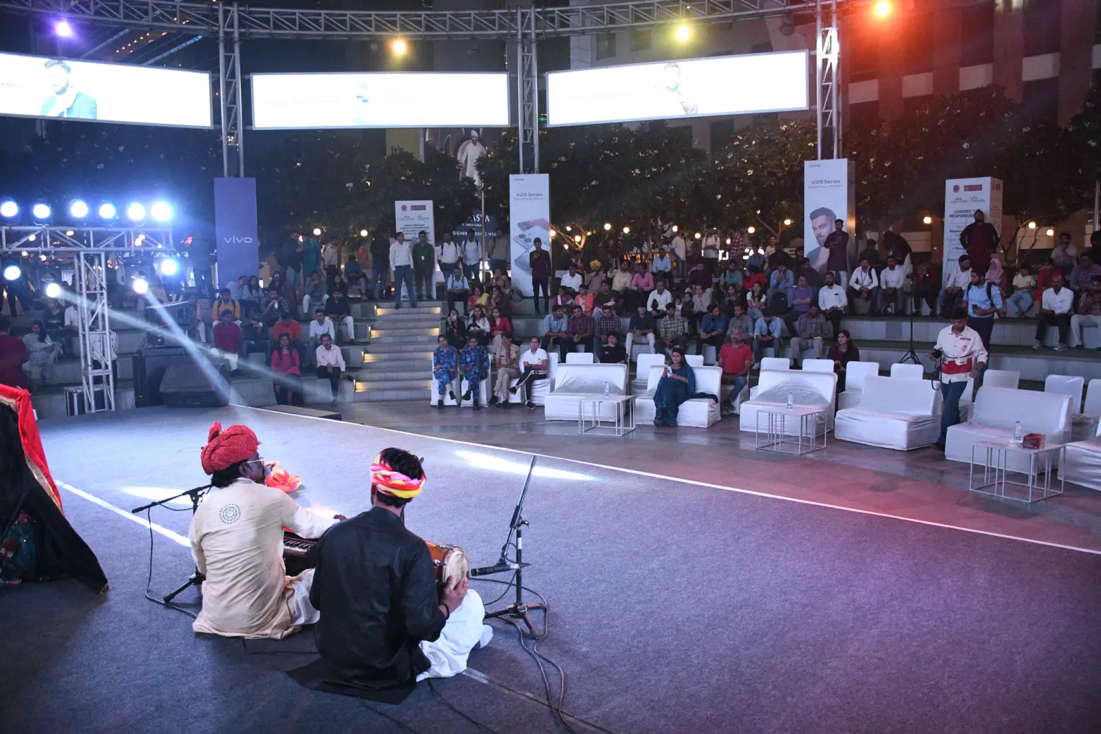 A community gathering in the evening at a Raahgiri Foundation event