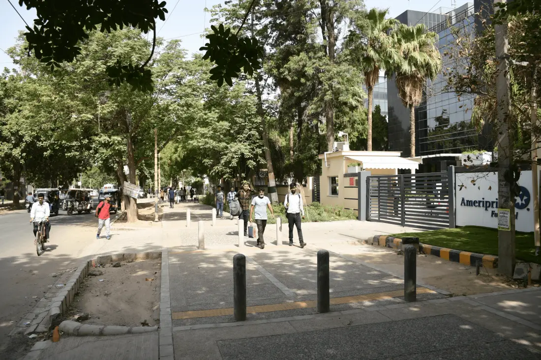 A calm, tree-lined street with protected walking space