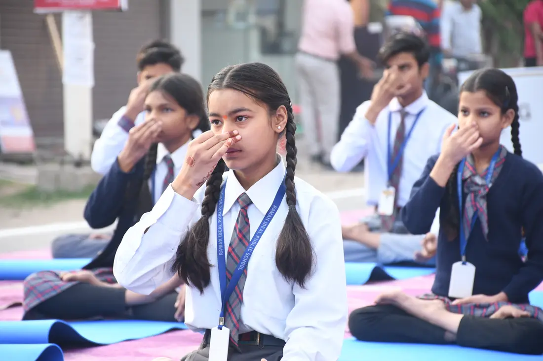 A schoolgirl sitting quietly during a morning session on a closed street